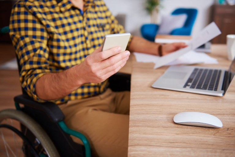 A human hand interacting with an accessible mobile website, reflecting adaptive web design principles.