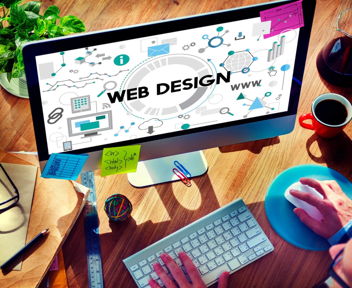 A Royston-based Corsto Web Design professional working on a project with 'WEB DESIGN' boldly highlighted on the computer screen, amidst symbols of technology and creativity.
